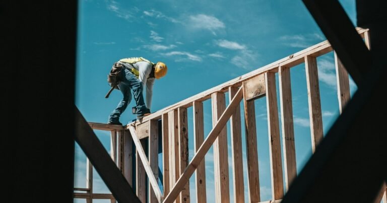 Construction worker in a hard hat on a steel building frame