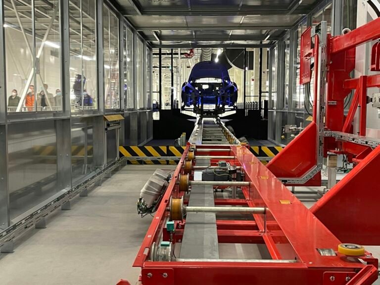 Car body moving along an automotive assembly line conveyor