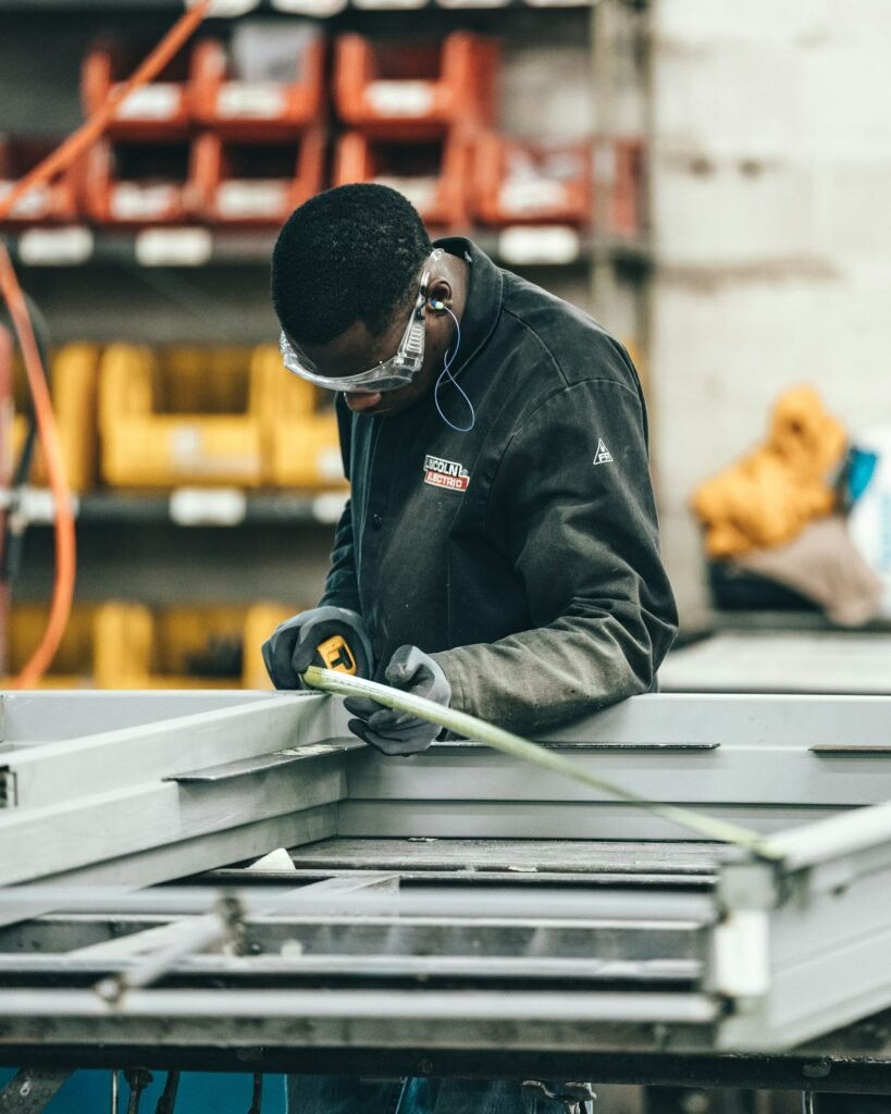 Technician installing industrial equipment in a factory
