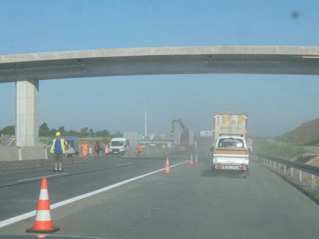 Construction worker on a travel assignment with work truck near a job site
