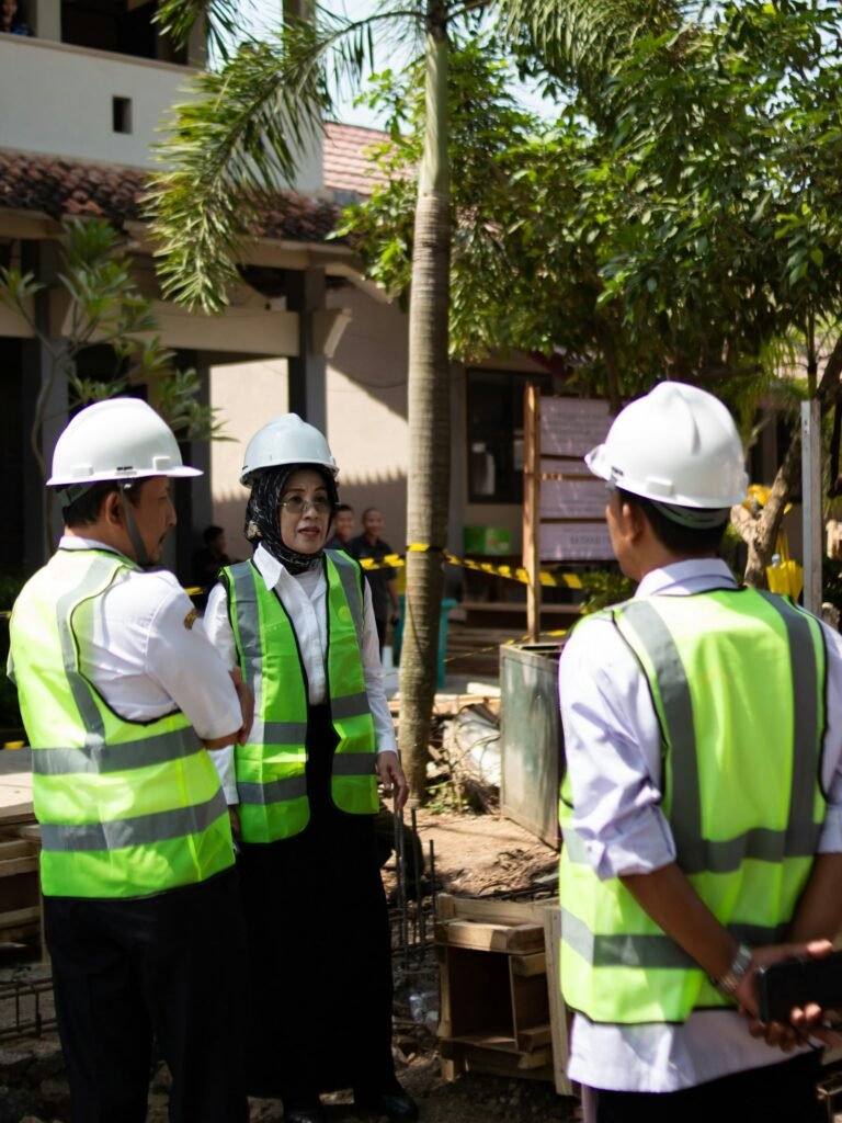 Safety manager in a hard hat walking a construction site