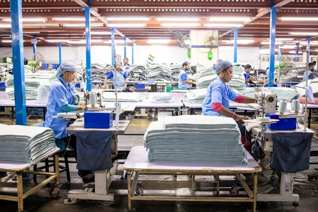Factory workers in safety vests on a U.S. plant floor