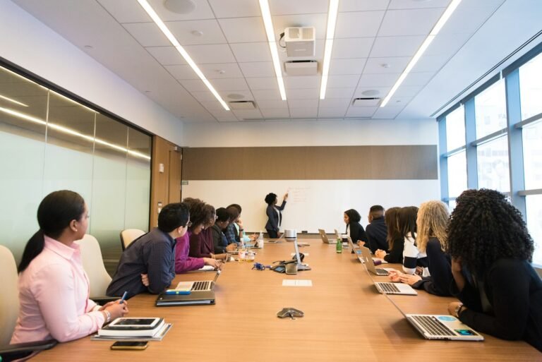 New hires in a meeting room listening to a presenter
