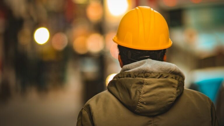 Worker in a yellow hard hat on a site