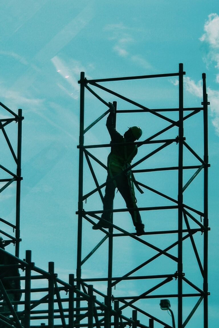 Worker standing on metal scaffolding