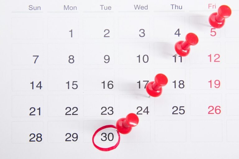 Calendar with red push pins