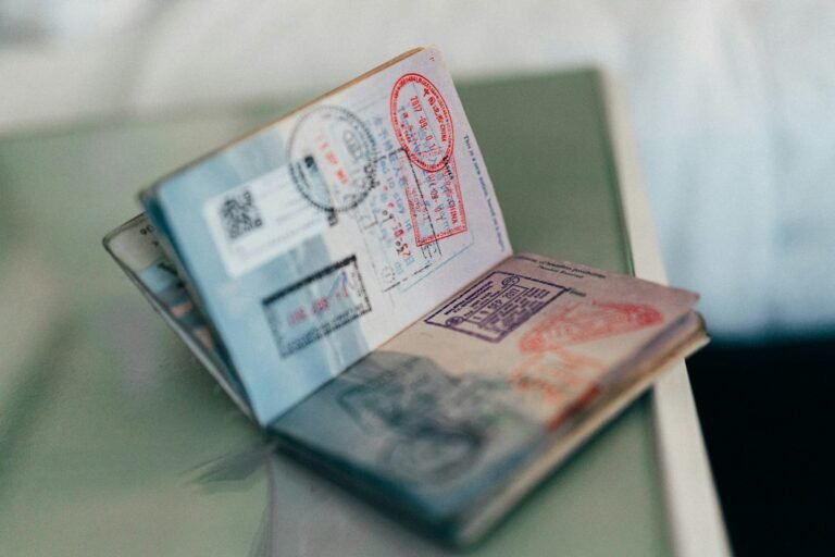 An open passport showing pages with colorful visa and entry stamps