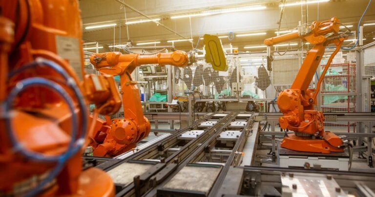 Robotic arms on an automated battery and EV production line