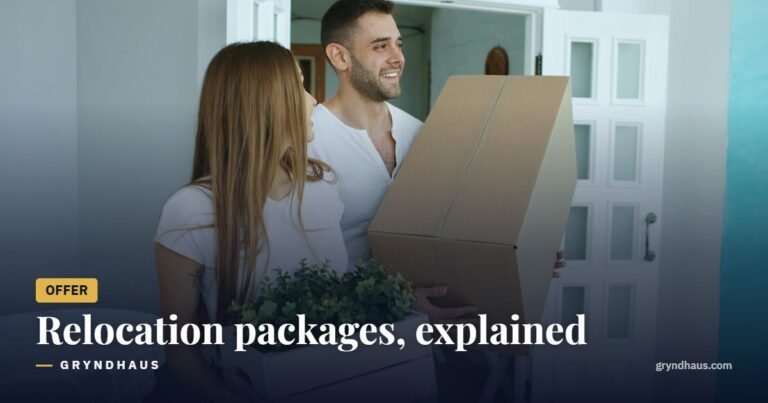 Couple carrying moving boxes into a new home